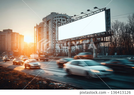 Clean White Billboard Positioned Near Busy Highway at Sunset in Urban Setting Clean White Billboard Positioned Near Busy Highway at Sunset in Urban Setting 136413126