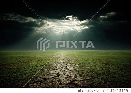 Cracked Ground in Desert Landscape with Dramatic Sky and Rays of Light Breaking Through Clouds Cracked Ground in Desert Landscape with Dramatic Sky and Rays of Light Breaking Through Clouds 136413129