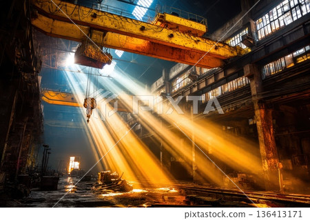 High Ceiling Factory Interior with Suspended Cranes and Dramatic Light Rays 136413171