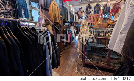 Inside a vintage clothing store An aisle filled with clothing Inside a vintage clothing store An aisle filled with clothing 136413217