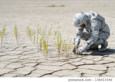 Researcher in Eco Suit Kneeling in Desert Examining Plants on Dry Cracked Soil Researcher in Eco Suit Kneeling in Desert Examining Plants on Dry Cracked Soil 136413340