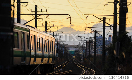Evening view of Mt. Fuji and a train taken on the JR Yokohama Line between Kamoi and Kozukue (Yokohama City) Evening view of Mt. Fuji and a train taken on the JR Yokohama Line between Kamoi and Kozukue (Yokohama City) 136414816