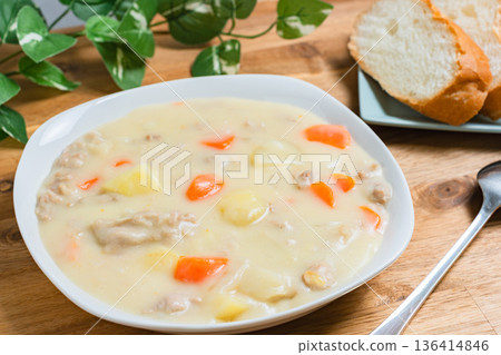 Cream stew served on a white plate. A warm image of a home-cooked meal with bread. Cream stew served on a white plate. A warm image of a home-cooked meal with bread. 136414846