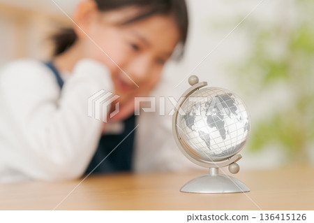 A girl watching the globe 136415126