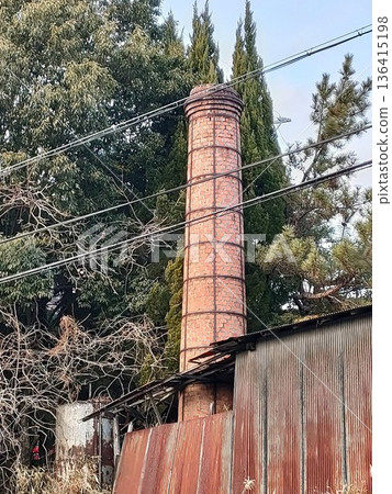 Brick chimney and rusty tin 136415198