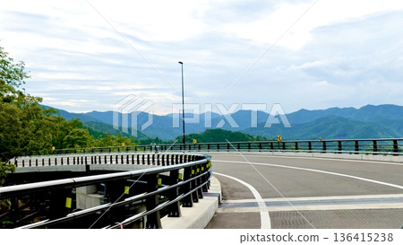 A view of the Sakamoto-Takahama Line approaching a large curve on the Birin Highway. Ishiyama, Oi-cho, Oi-gun, Fukui Prefecture 136415238