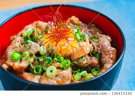 Pork bowl topped with egg yolk 136415330