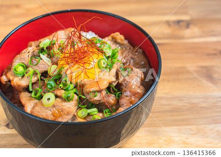 Pork bowl topped with egg yolk 136415366