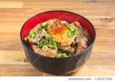 Pork bowl topped with egg yolk Pork bowl topped with egg yolk 136415369