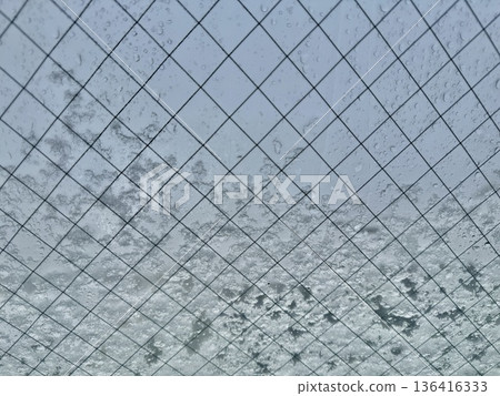 Stock Photo: Image of snow and water droplets on a window 136416333