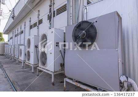 Air conditioner compressor installed in old building.  136417237