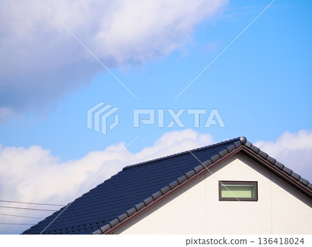 Blue sky and the gable roots of a newly built detached house Blue sky and the gable roots of a newly built detached house 136418024