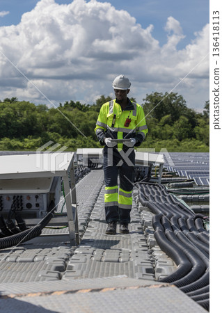 Engineer Checking and working setup Floating solar panels or solar cell Platform system on the lake. Engineer Checking and working setup Floating solar panels or solar cell Platform system on the lake. 136418113