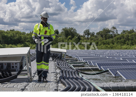 Engineer Checking and working setup Floating solar panels or solar cell Platform system on the lake. Engineer Checking and working setup Floating solar panels or solar cell Platform system on the lake. 136418114