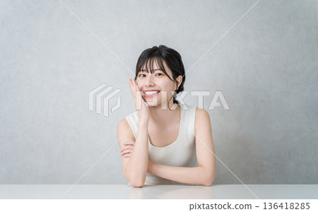 Smiling Asian woman with beautiful skin with a cheek (beauty, esthetic, skin care image) Smiling Asian woman with beautiful skin with a cheek (beauty, esthetic, skin care image) 136418285