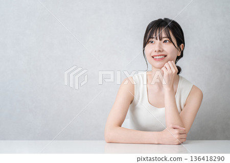 Smiling Asian woman with beautiful skin with a cheek (beauty, esthetic, skin care image) 136418290