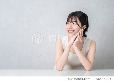 Smiling Asian woman with beautiful skin with a cheek (beauty, esthetic, skin care image) 136418293