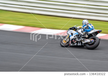 Panning shot of a motorbike racer on a circuit, a cornering scene with a sense of speed 136418322