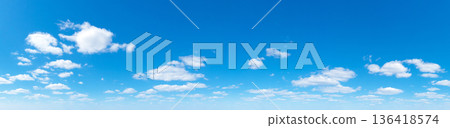 Panoramic fluffy cloud in the blue sky. Sky with cloud on a sunny day. Panoramic fluffy cloud in the blue sky. Sky with cloud on a sunny day. 136418574