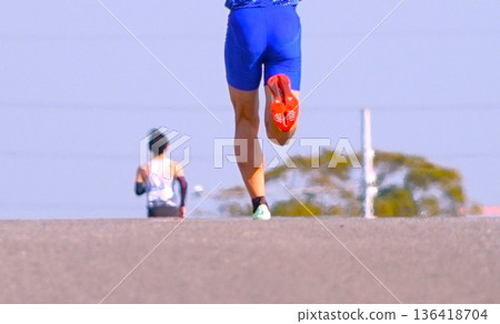 Marathon runners running up and down the slope 136418704