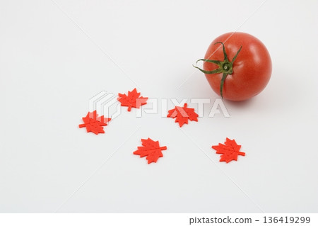 Large, ripe tomatoes and autumn decorations Large, ripe tomatoes and autumn decorations 136419299