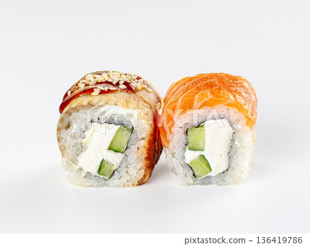 Two Japanese sushi rolls with salmon and eel, cream cheese and cucumber, isolated on a white background. 136419786