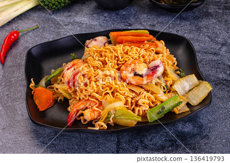 Asian noodles with seafood and vegetables 136419793
