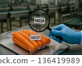 Vacuum-packed carrots under HACCP magnifying glass inspection highlighting packaging control and food safety compliance in a production facility 136419989