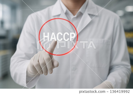 Food safety engineer pressing HACCP button on virtual interface to activate hazard control and verification systems inside clean processing environment 136419992