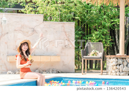 A woman playing in the pool during summer vacation (travel, resort, vacation) A woman playing in the pool during summer vacation (travel, resort, vacation) 136420543