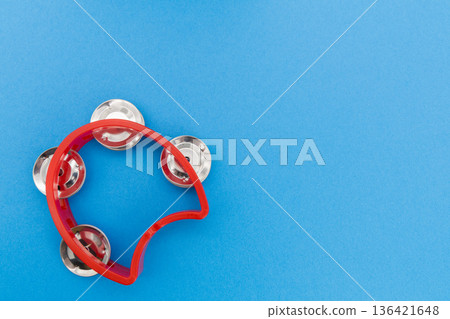 A red tambourine on a blue background A red tambourine on a blue background 136421648