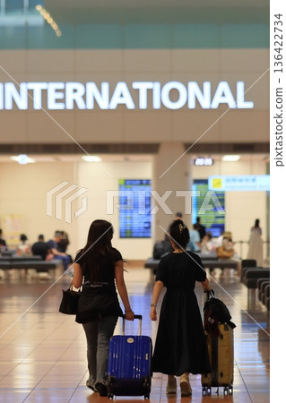 Passengers heading to the international departure lobby, Haneda Airport lobby at night Passengers heading to the international departure lobby, Haneda Airport lobby at night 136422734
