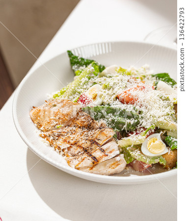 Caesar salad with grilled chicken and parmesan 136422793