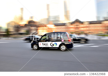 Taxi running in front of Tokyo Station Marunouchi South Exit 136422988