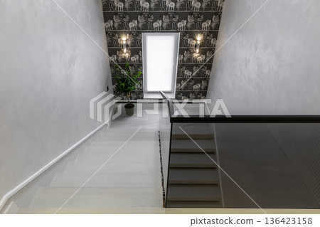High angle view of modern staircase with decorative wallpaper High angle view of modern staircase with decorative wallpaper 136423158