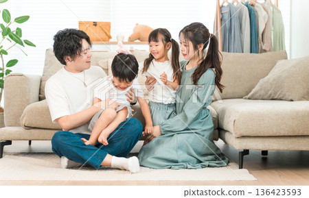 Family relaxing on the sofa at home, family, childcare (affection, family love) Family relaxing on the sofa at home, family, childcare (affection, family love) 136423593