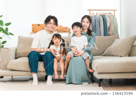 Family relaxing on the sofa at home, family, childcare (affection, family love) Family relaxing on the sofa at home, family, childcare (affection, family love) 136423594