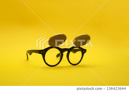 Sunglasses with double glass on a yellow background 136423644