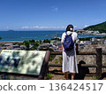 Woman looking at the sea 136424517