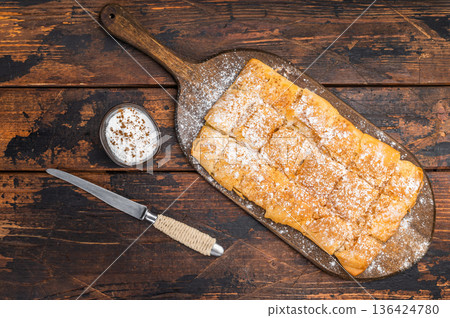 Milk pie custard pastry made of crispy filo layers sliced and served as breakfast or dessert on wooden board. 136424780