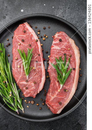 Fresh uncooked picanha steak with fat cap, sirloin cap beef cut with rosemary and peppercorns, flat lay with copy space Fresh uncooked picanha steak with fat cap, sirloin cap beef cut with rosemary and peppercorns, flat lay with copy space 136424801