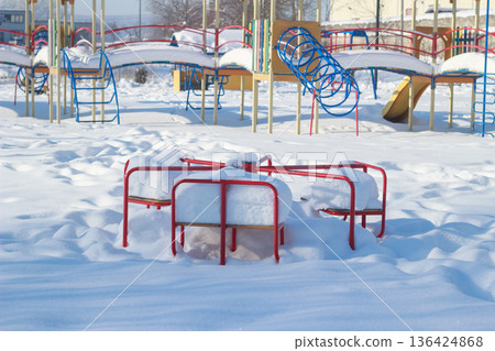 Colorful Children Playground Covered in Thick Snow on Sunny Winter Day Colorful Children Playground Covered in Thick Snow on Sunny Winter Day 136424868