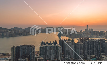 Kowloon Bay skyline glowing during early evening twilight Feb 8 2026 Kowloon Bay skyline glowing during early evening twilight Feb 8 2026 136424958