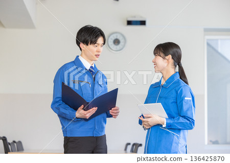 Men and women in work clothes Men and women in work clothes 136425870