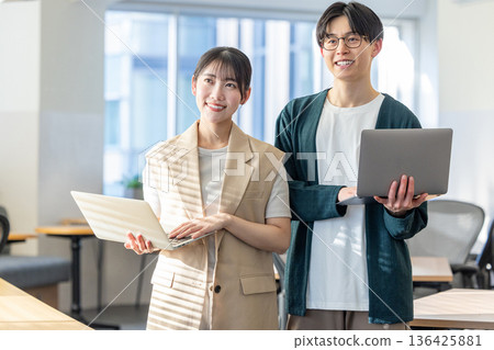 Male and female engineers working in the office 136425881