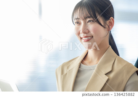 A woman who works with a smile A woman who works with a smile 136425882