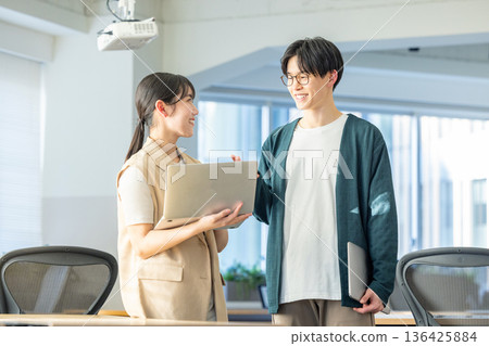 Male and female engineers working in the office Male and female engineers working in the office 136425884