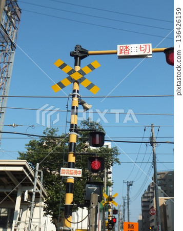 Railroad crossing in front of the station 136426159