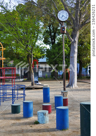 Everyday scene in a city park with a clock Everyday scene in a city park with a clock 136426231