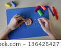 Kids decorating plasticine pizza flat lay creative learning activity handmade food craft fine motor skills development education concept 136426427